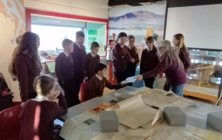 pupils looking at old maps
