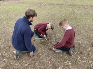 3 people in field planting