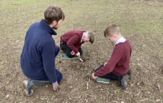 3 people in field planting