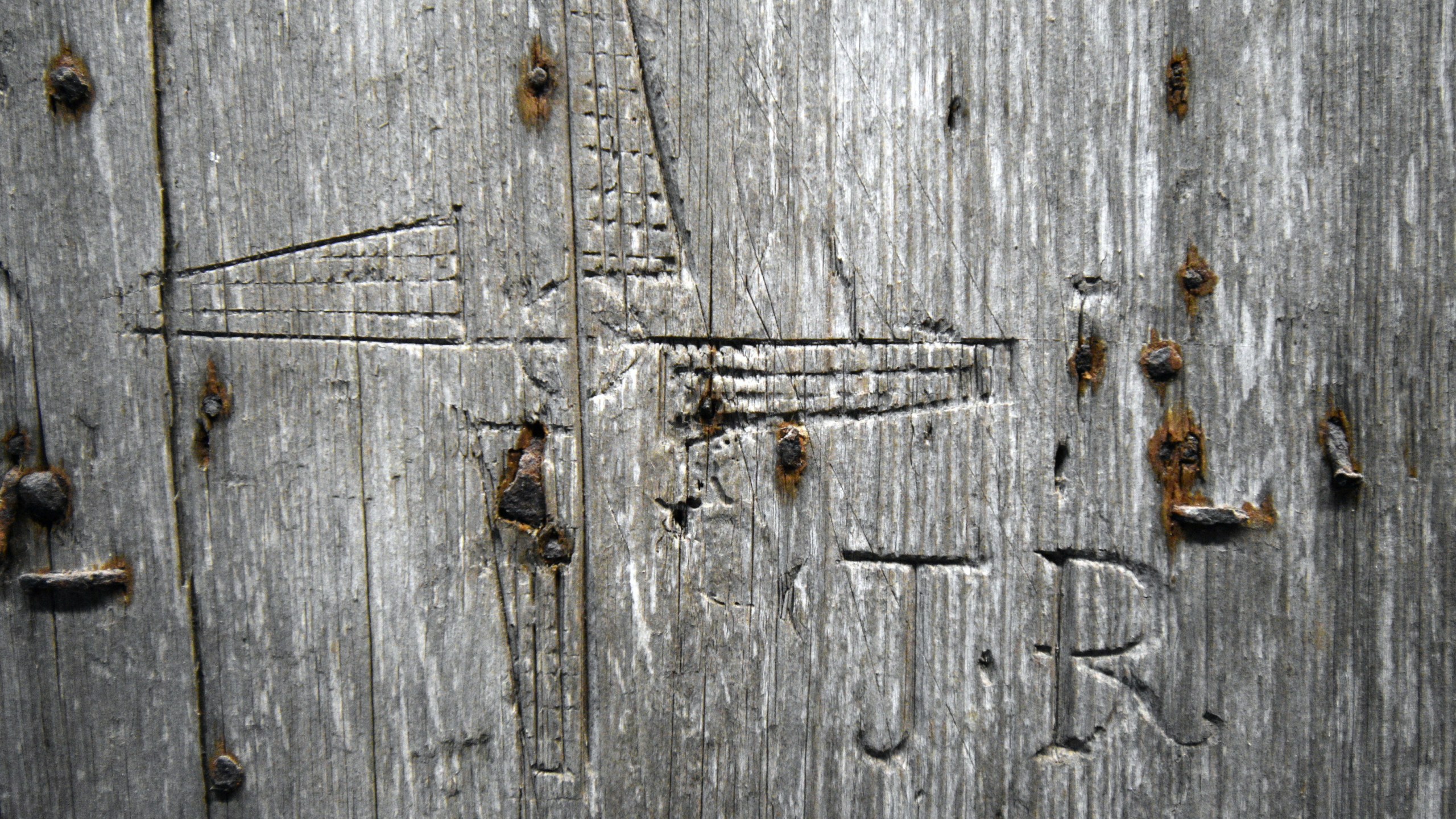 initials carved into a piece of wood